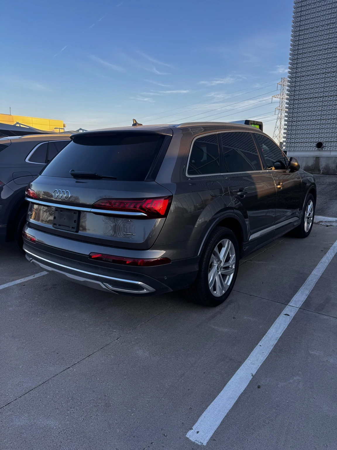 Gray Audi SUV with tinted windows photographed from the rear