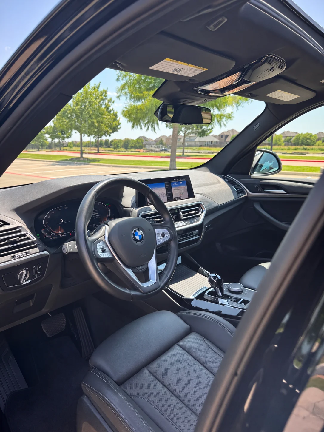 BMW interior photographed through the driver door