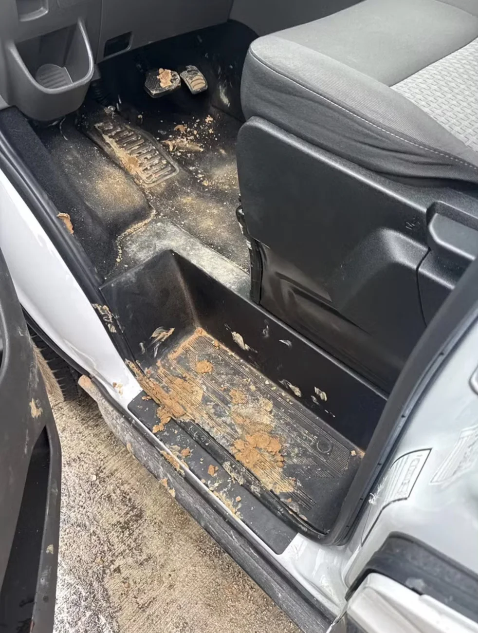 Passenger van floor and entry step before professional cleaning