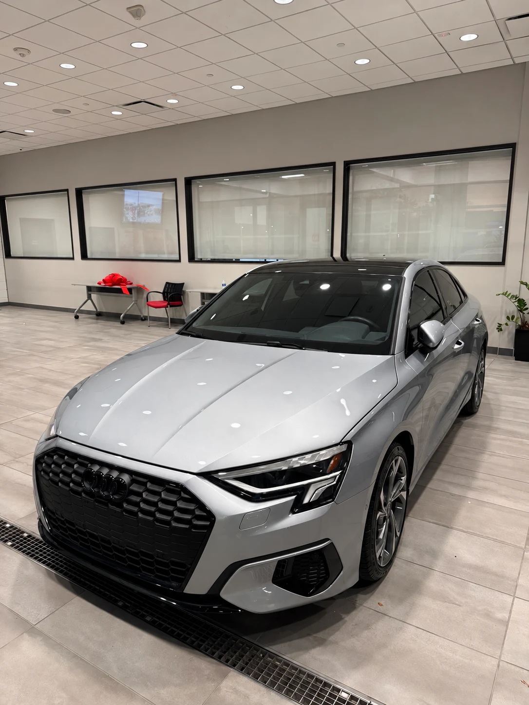 Silver Audi A3 inside a dealership showroom