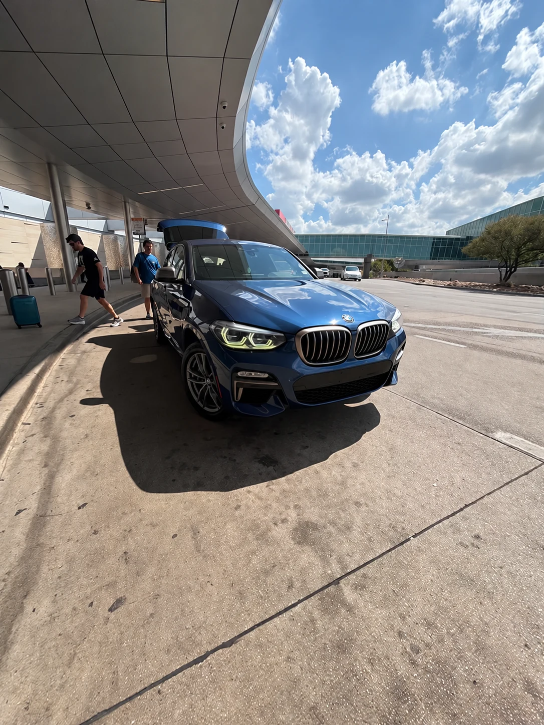 TOGOLuxury BMW X4 at an airport terminal for a personal handover