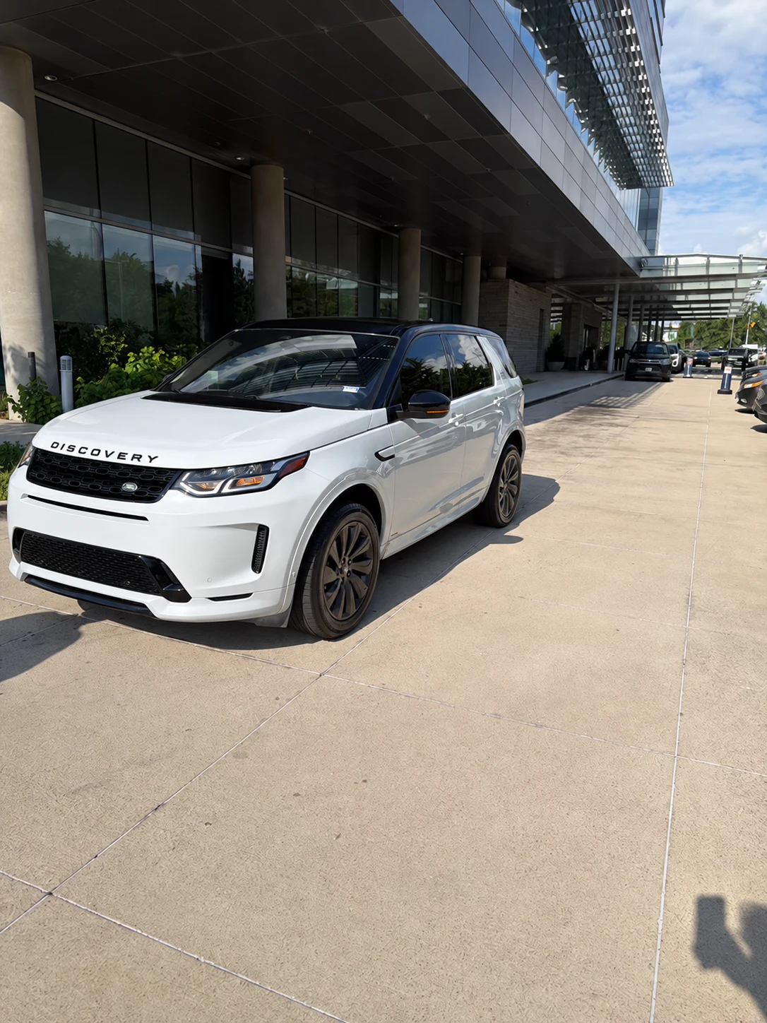 White Land Rover Discovery Sport at an airport terminal