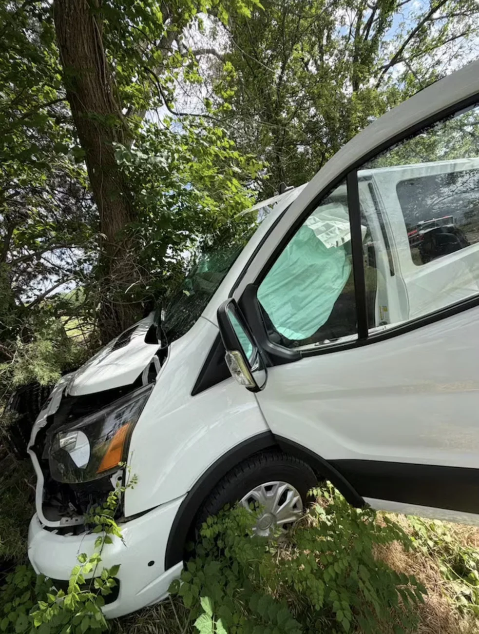 Passenger van front damage documented for repair assessment