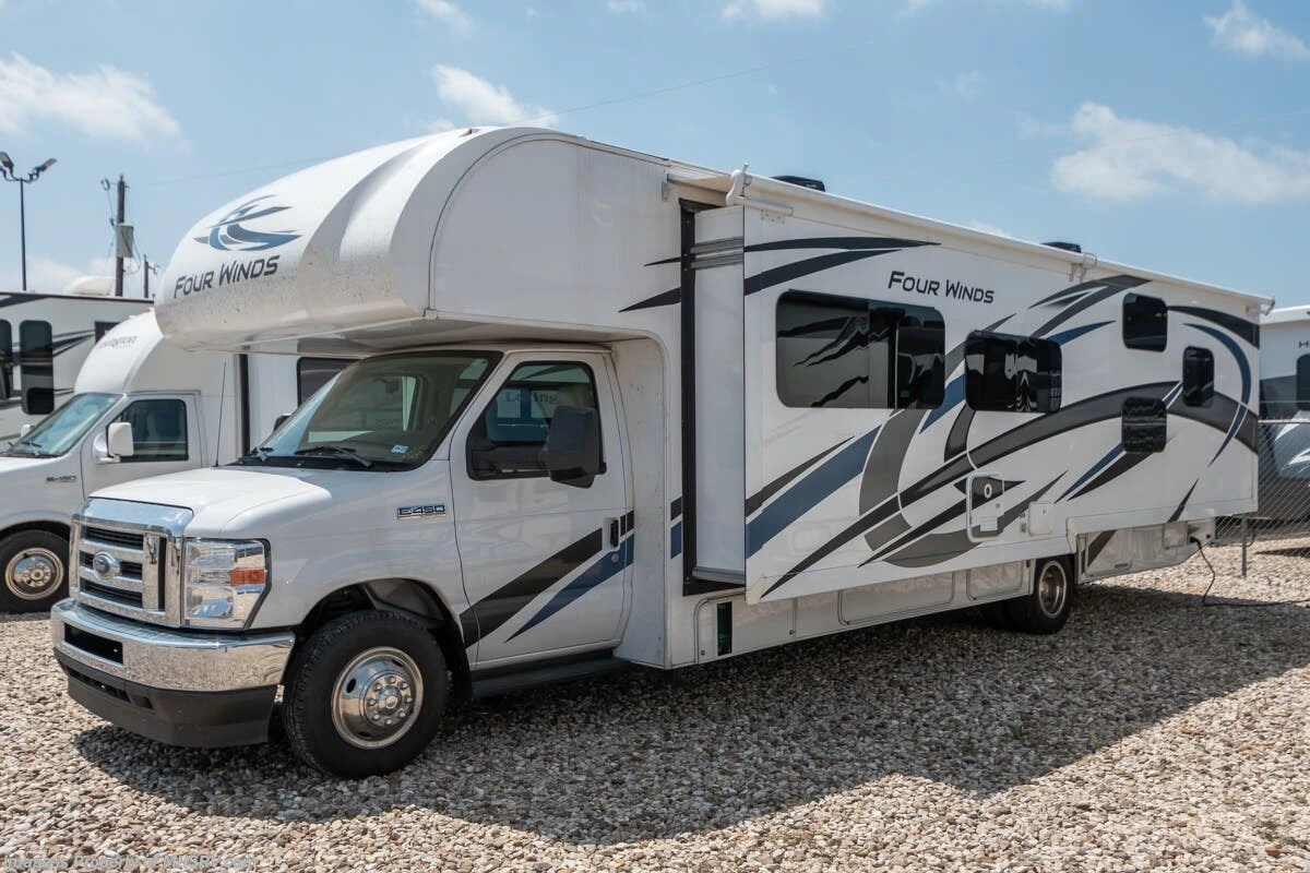Reference photograph of a spacious Class C bunkhouse RV with a cab-over sleeping area